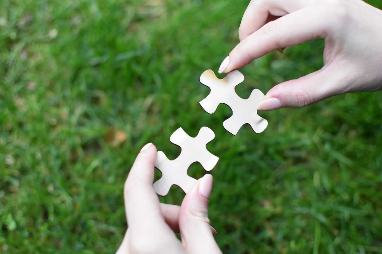 a person is holding a piece of puzzle