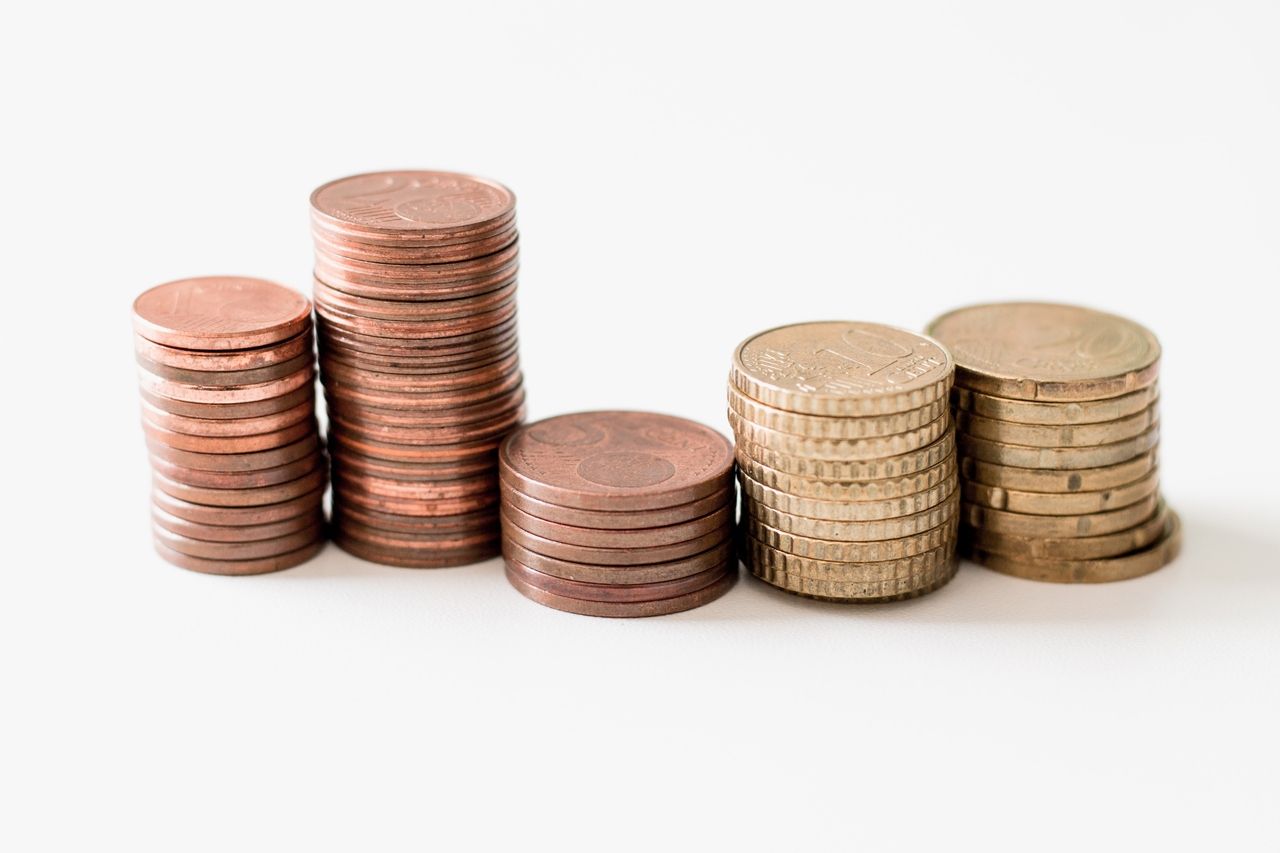 a stack of coins on a plain white background