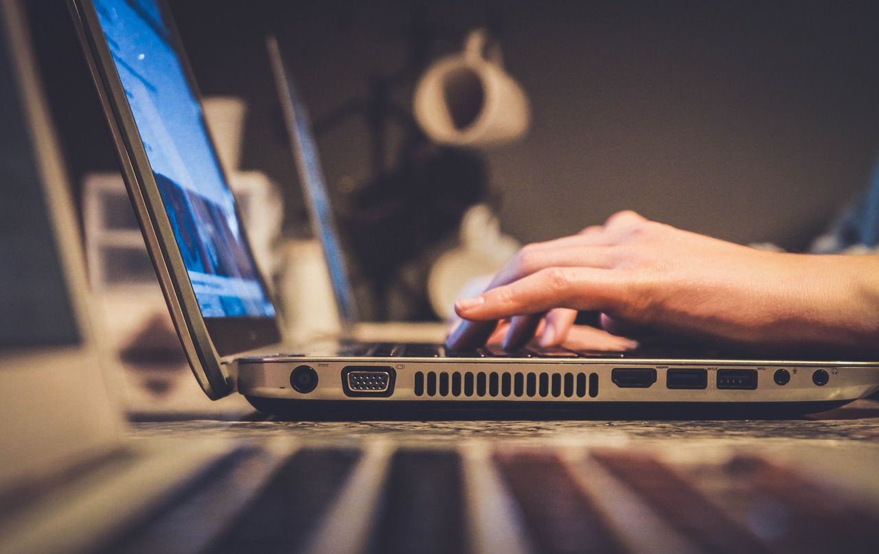 a person is using silver laptop