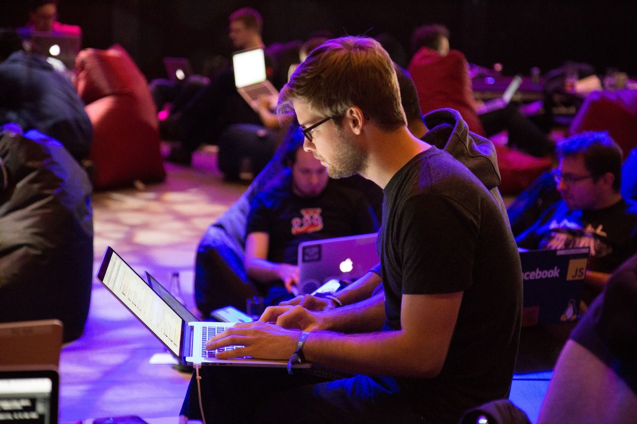 a group of programmer men writing code