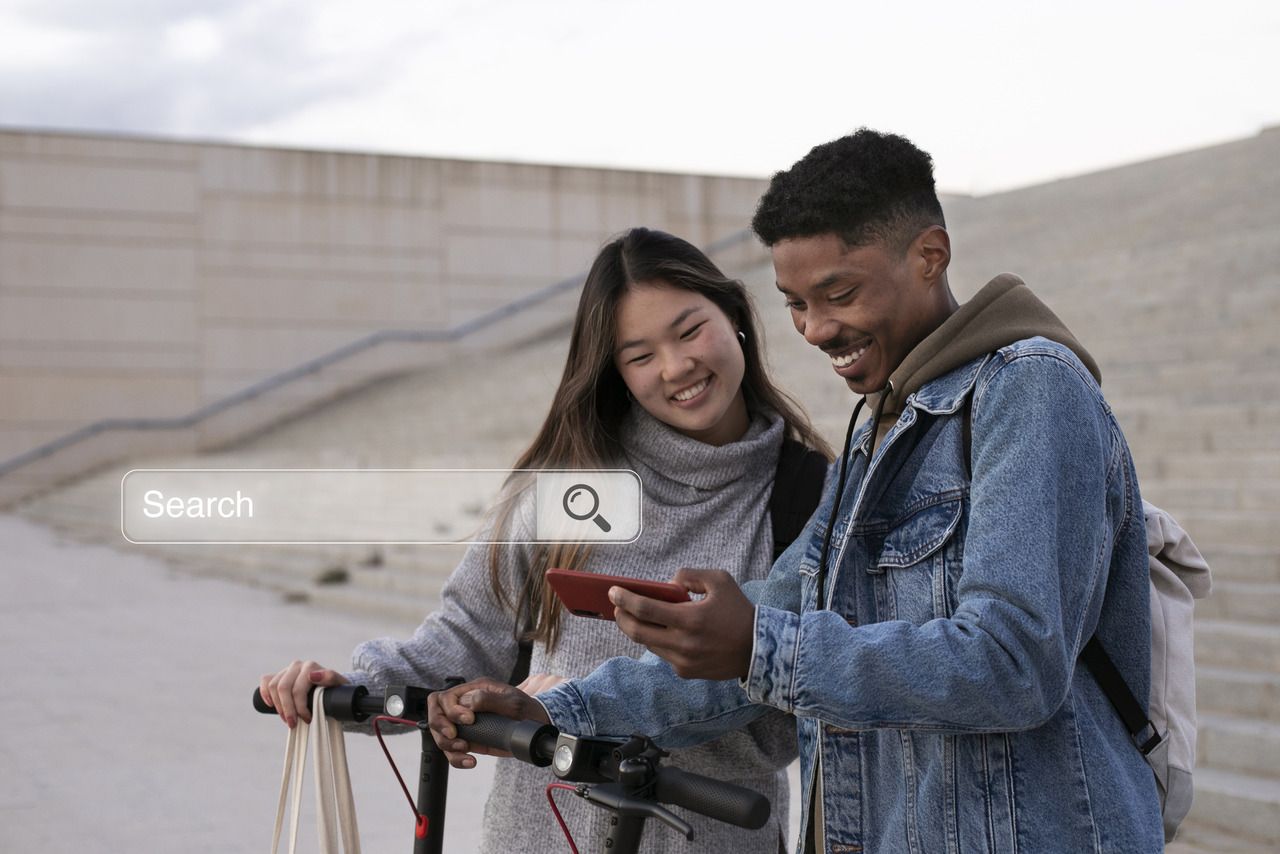 a man and a lady looking at smartphone and smiling