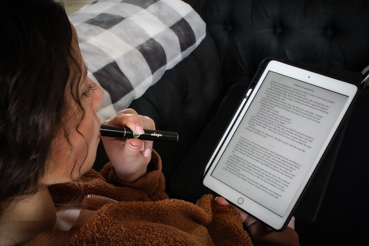 a young woman reading PDF from tablet 