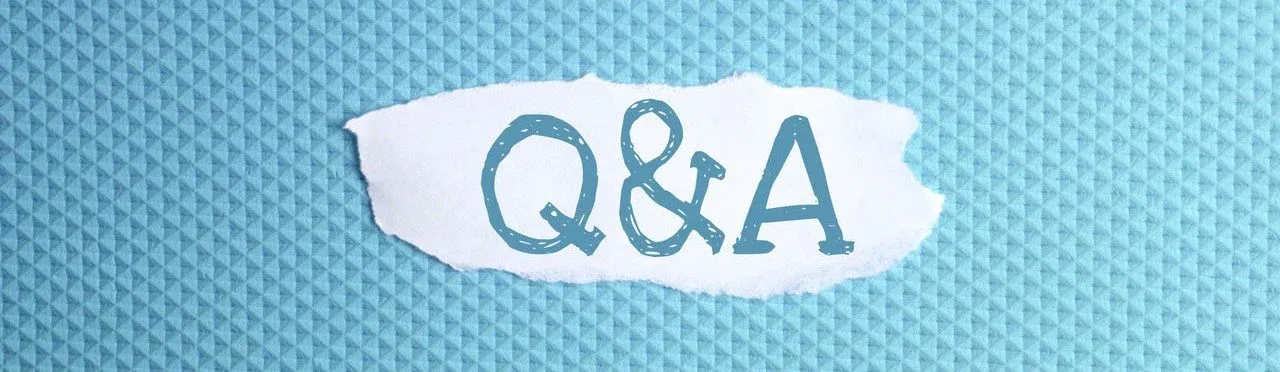 a torn paper written with inscription Q&A